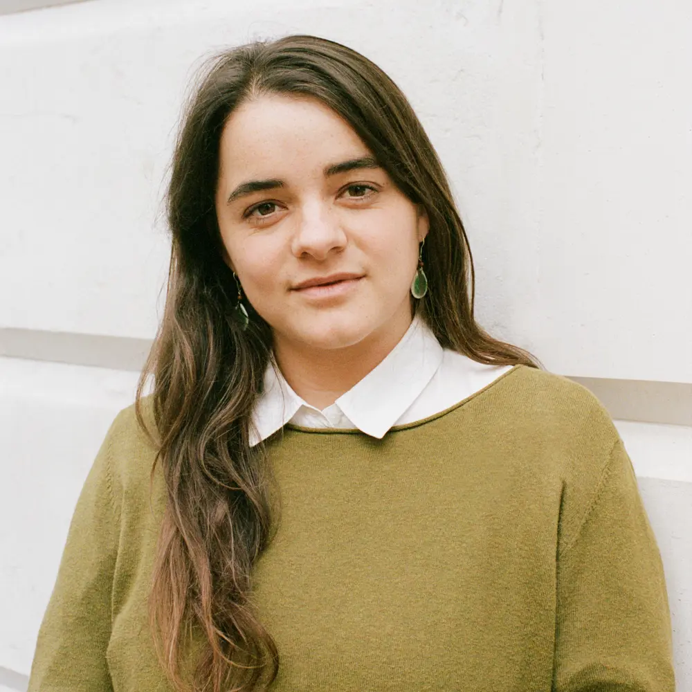A photo of Nora Ammann smiling at the camera against a white background.