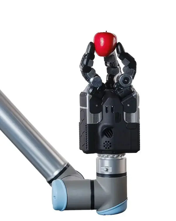 Robot hand holding a red apple