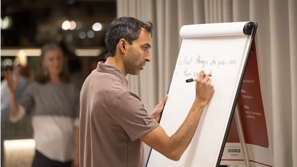 Suraj Bramhavar writing on a whiteboard