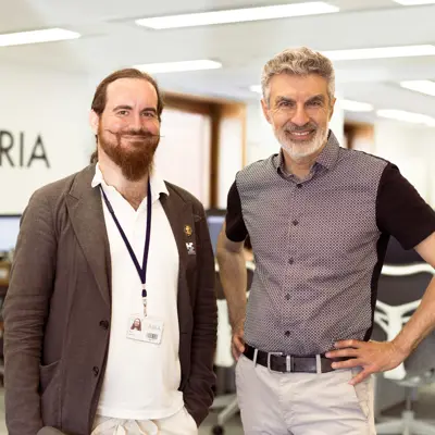 A photo of Yoshua Bengio and David 'davidad' Dalyrmple smiling for the camera.