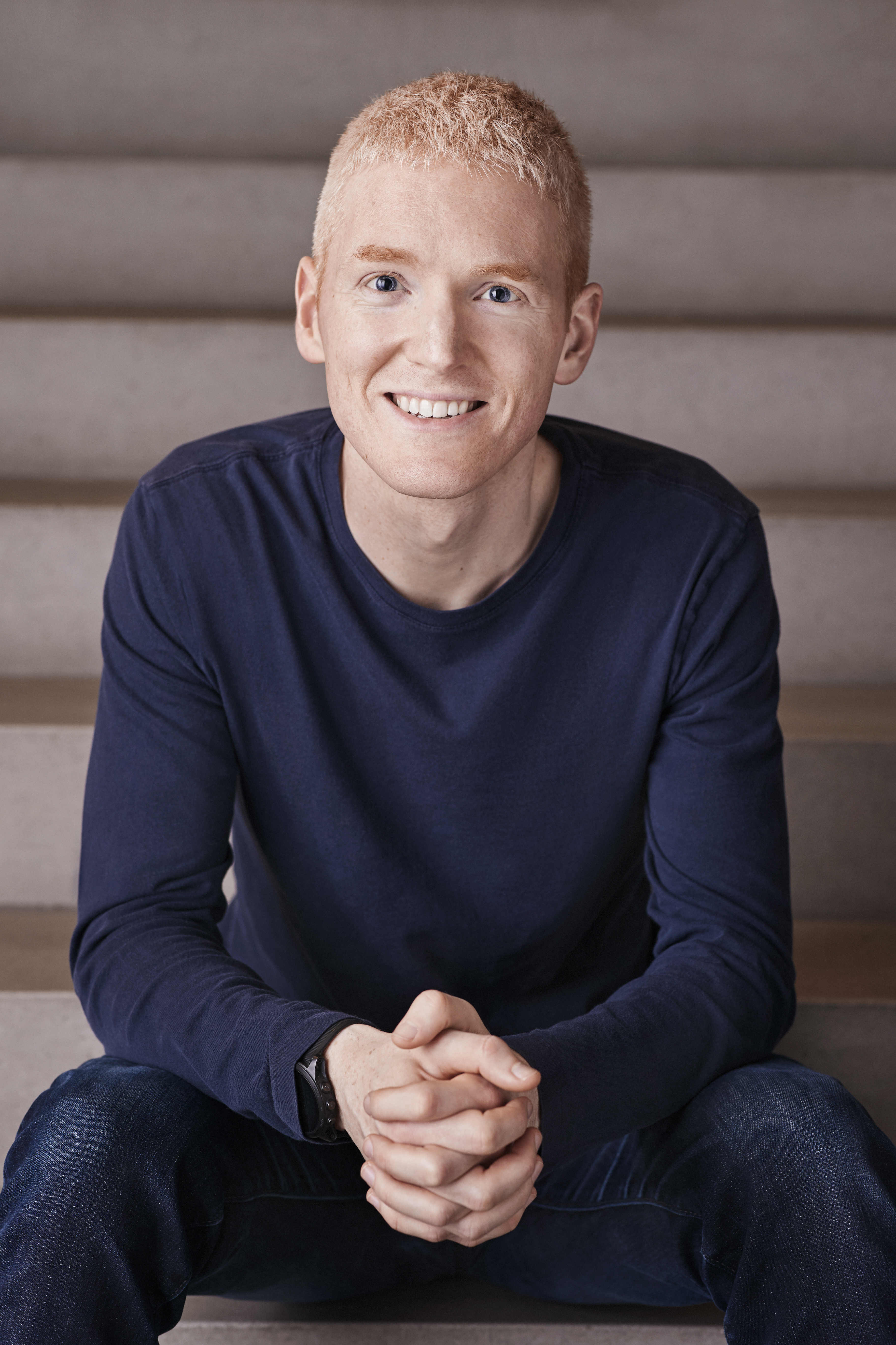 Photo of Patrick Collison sitting on some steps