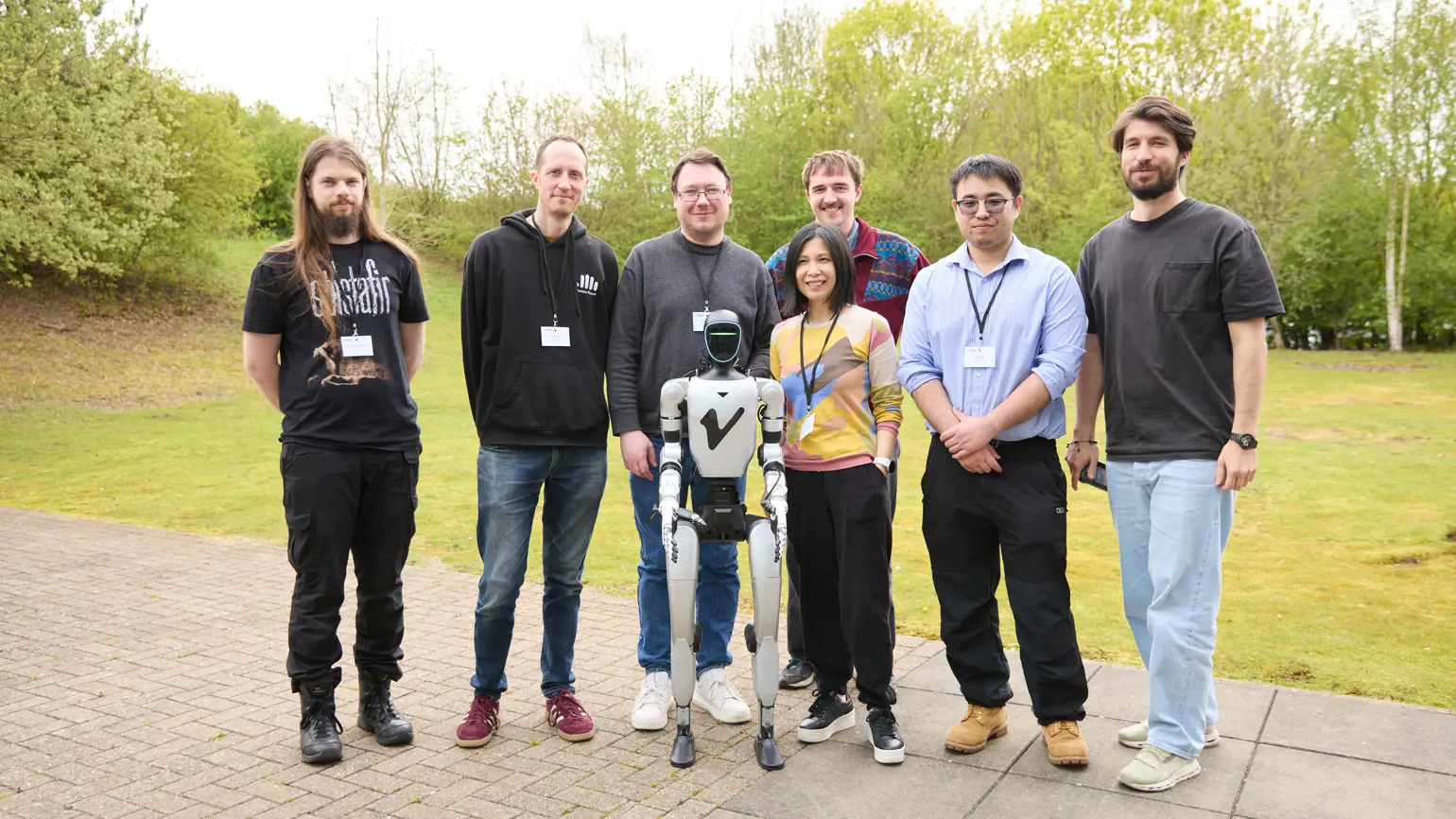 Photo of a group of Smarter Robot Bodies Creators standing outside with a robot