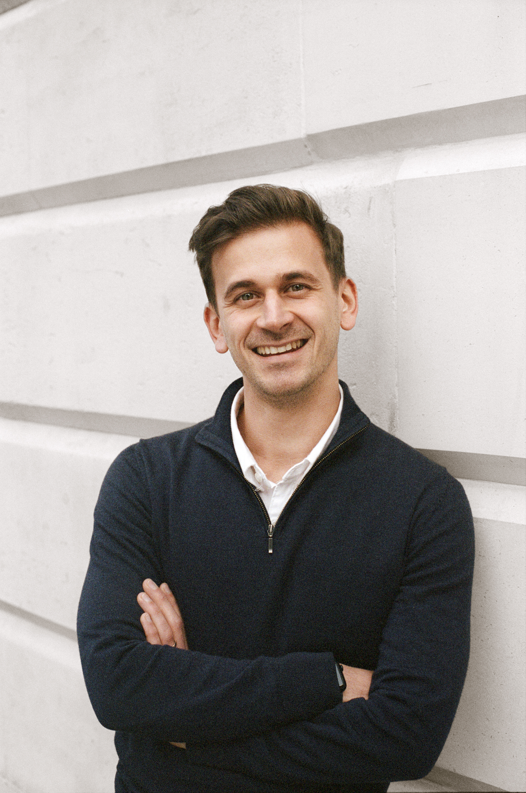 A photo of Fabrizio smiling and standing in front of a white background. 