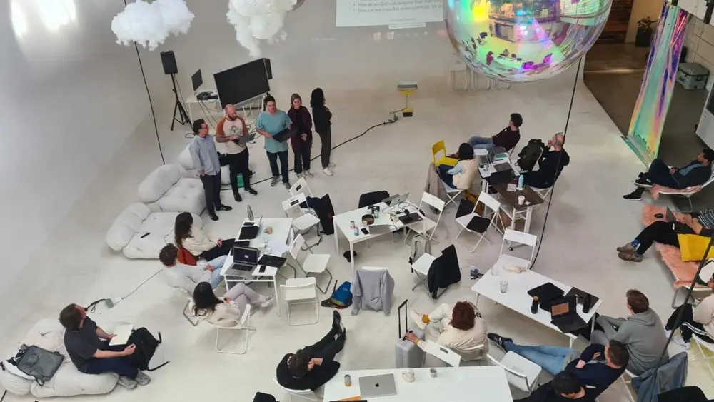 Birds eye view of a room of people in discussion at ARIA's Innovator Circle pilot