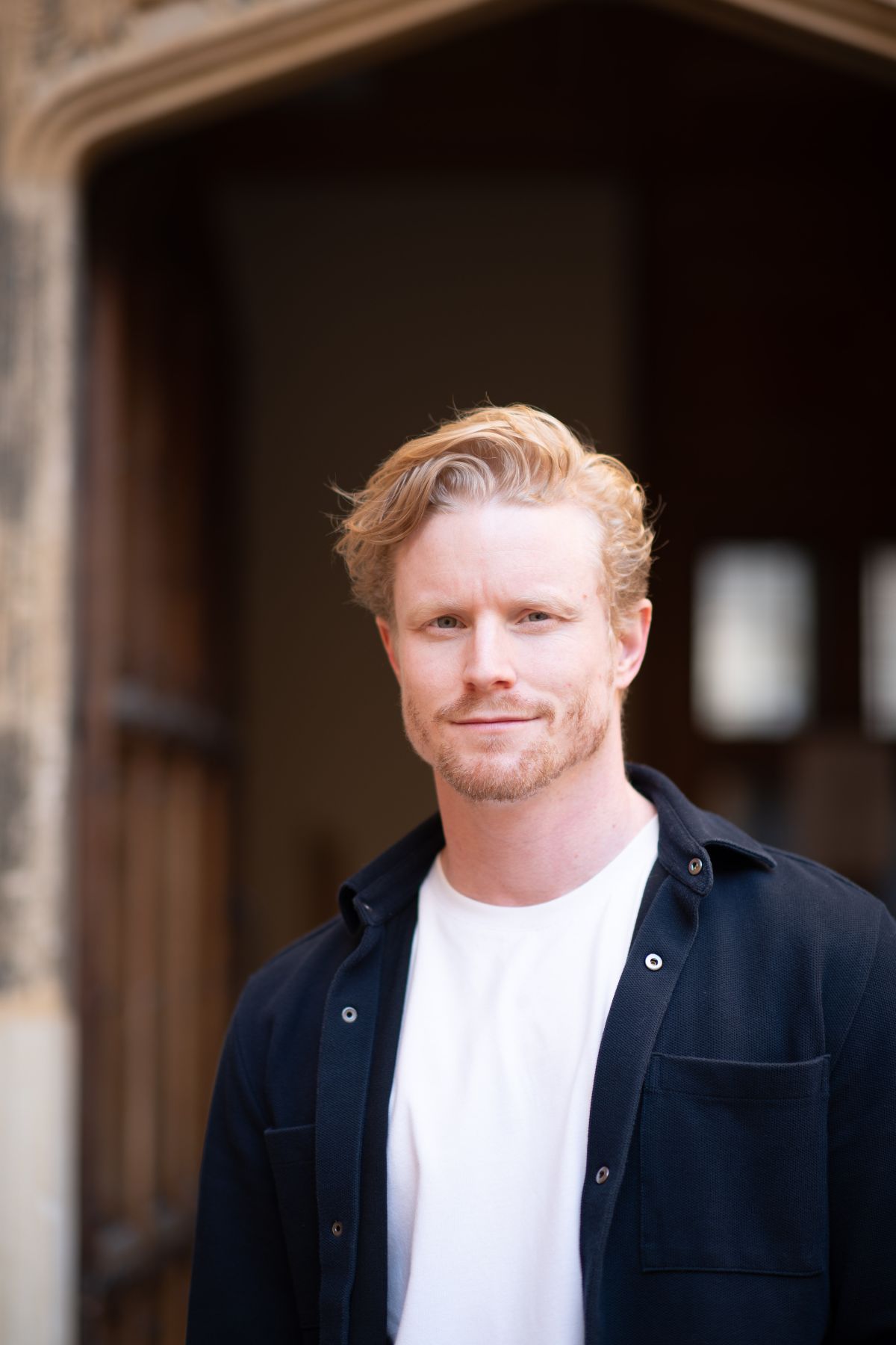 A photo of Mike Farrar standing outside a building